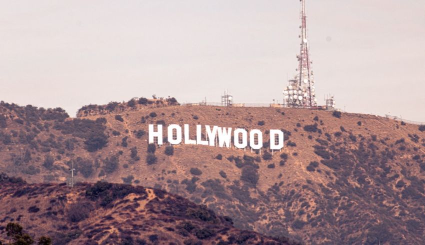 The hollywood sign is on top of a hill.