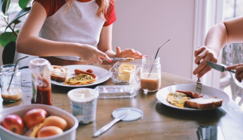 Two women eating breakfast at a table.