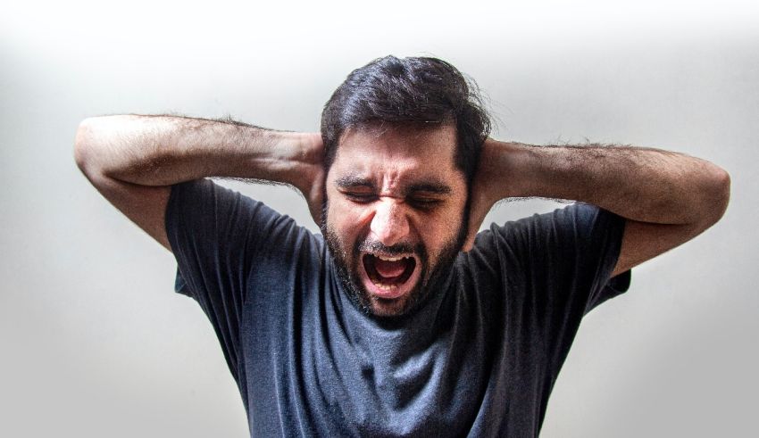 A man covering his ears with his hands.