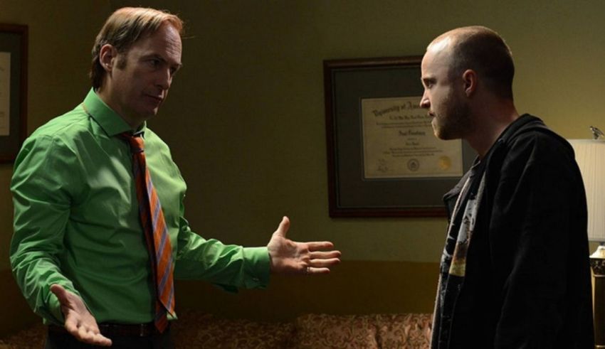 Two men in a room talking to each other.