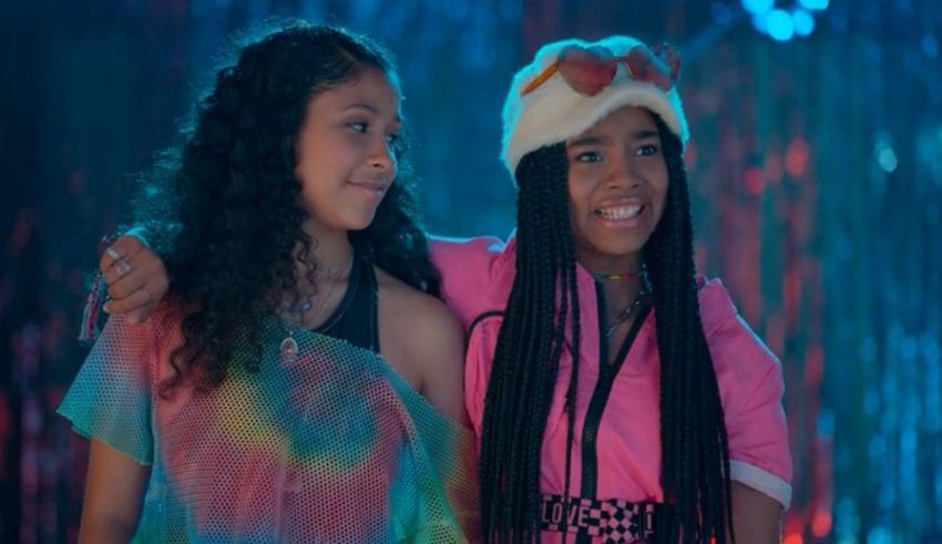 Two young girls standing next to each other.