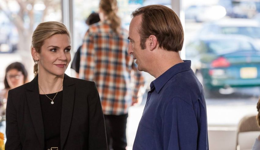 A man and woman talking to each other in an office.