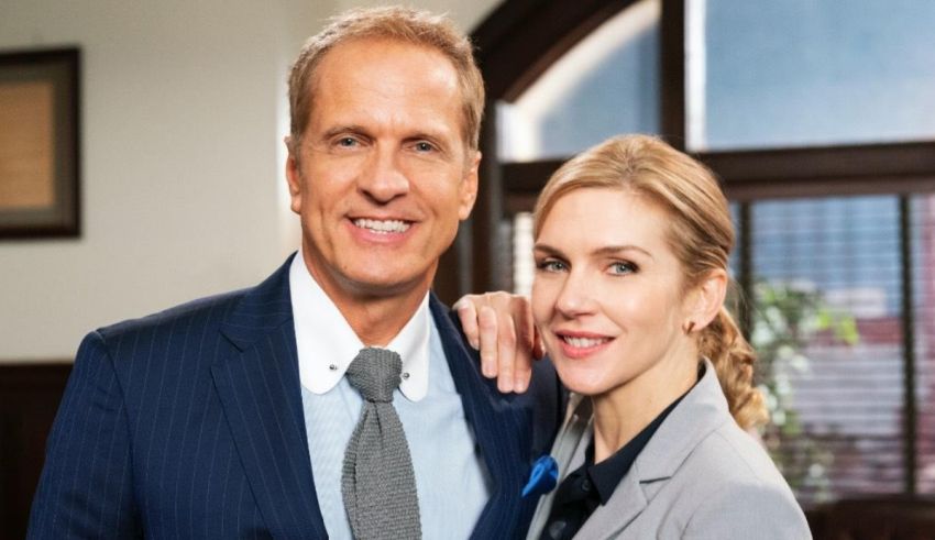 A man and woman posing for a picture in an office.