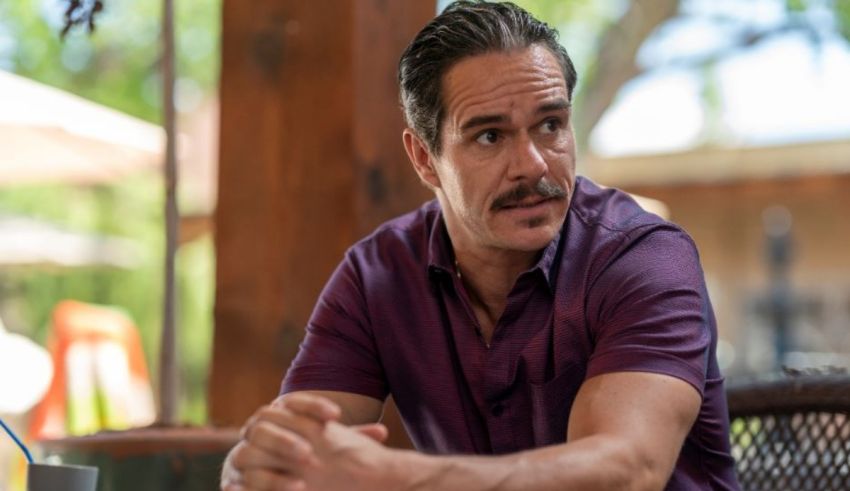 A man sitting at a table with a mustache.