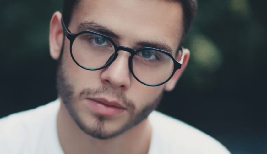 A man wearing glasses and staring at the camera.