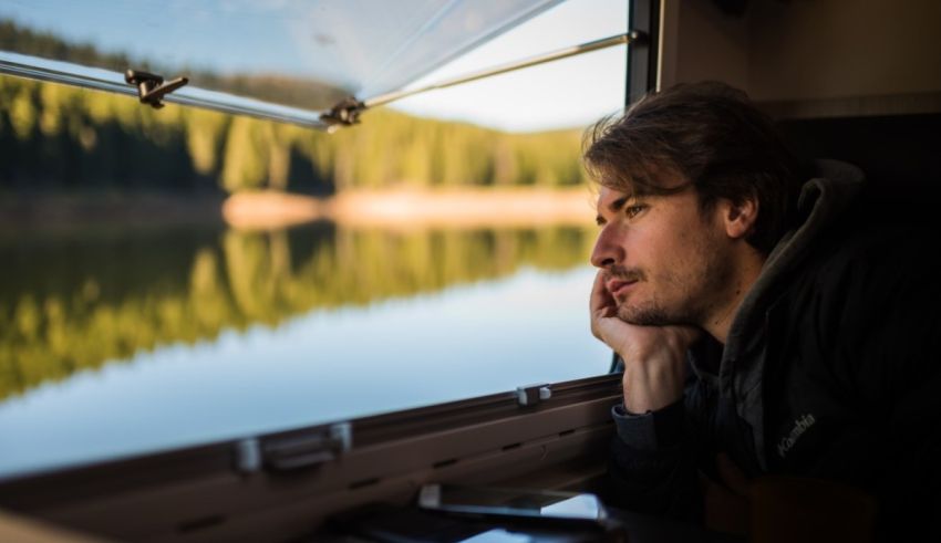 A man looking out the window of a train.