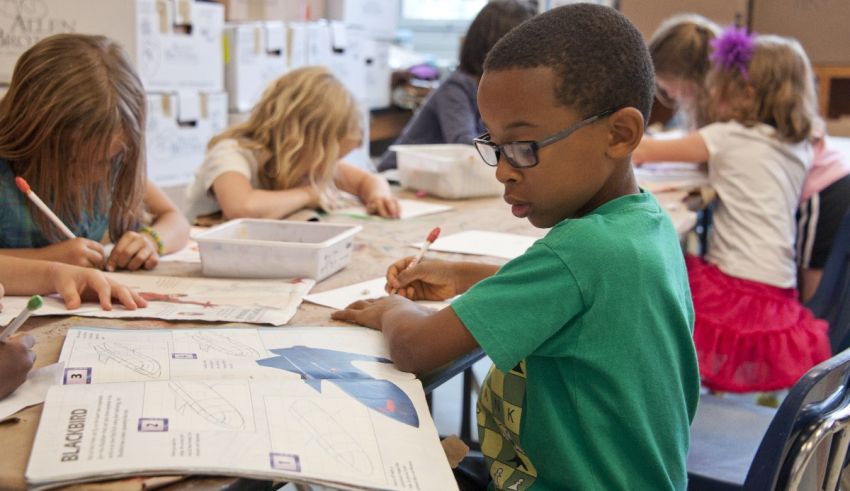 A group of children sitting at desks in a classroom.