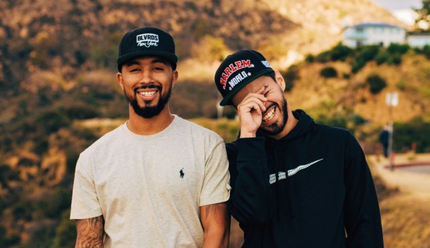 Two men wearing hats standing next to each other.