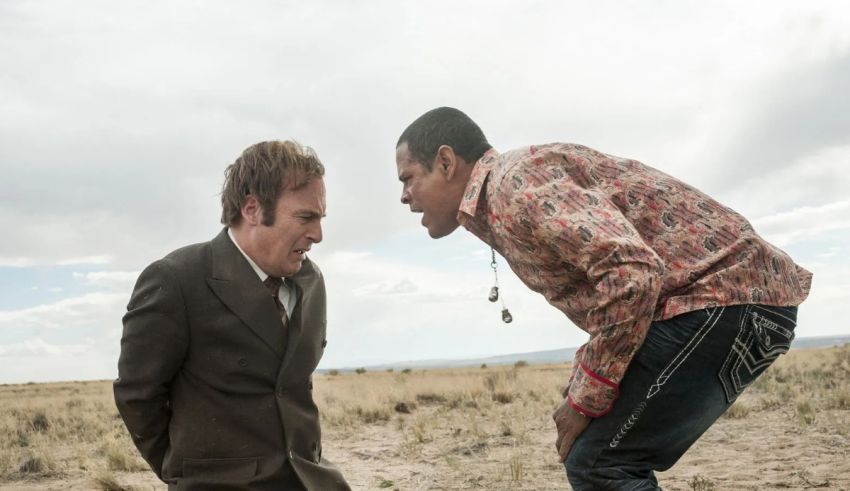 Two men standing in the middle of a desert.