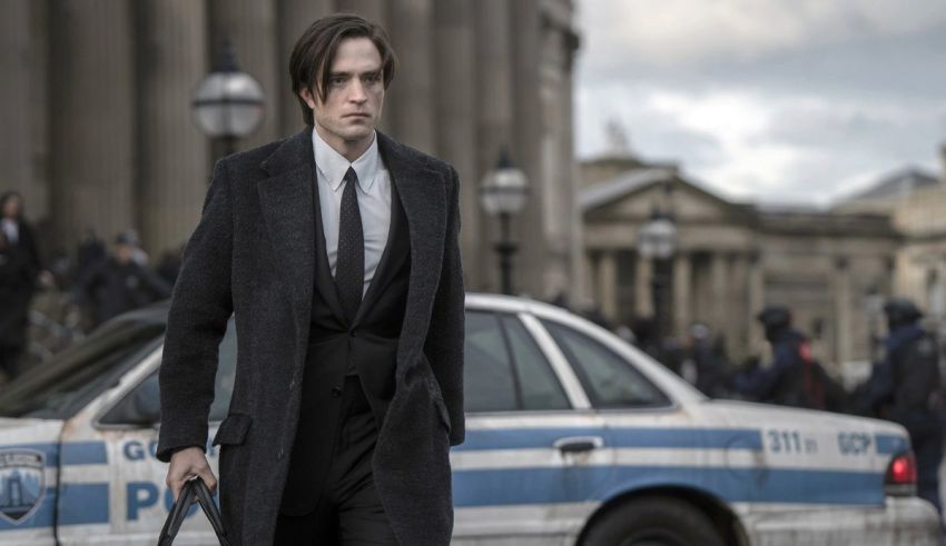 A man in a suit walking down a street.