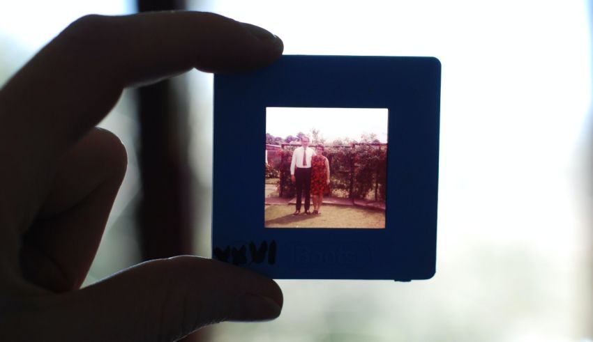 A person holding up a photo of a person.