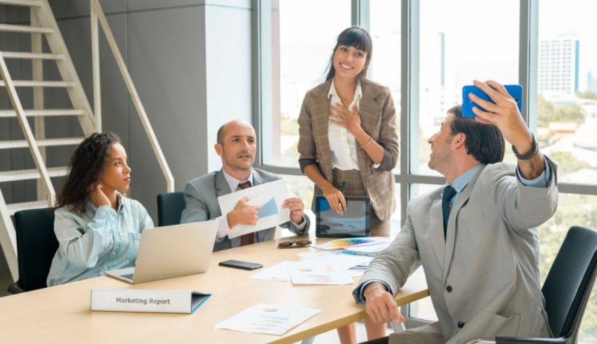 A group of business people taking a selfie in a conference room.