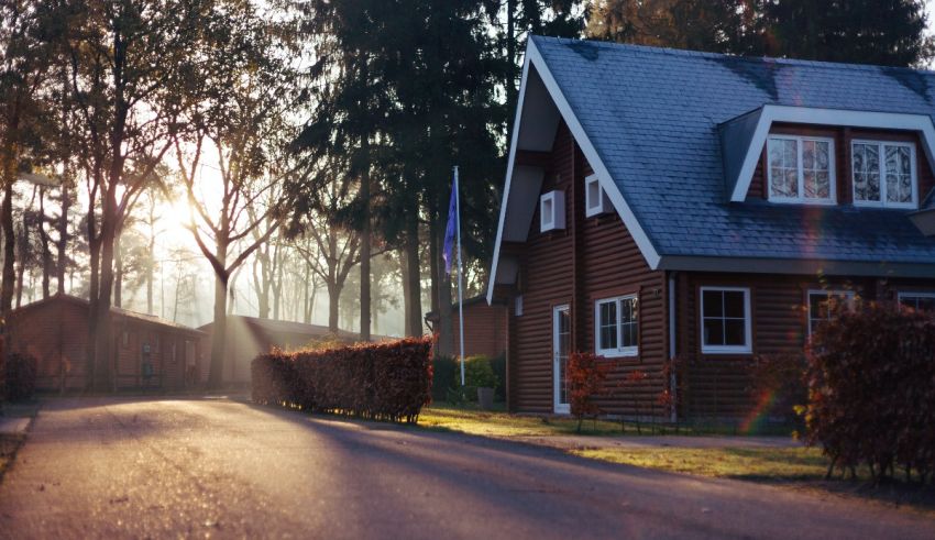 A house on a road with trees in the background.