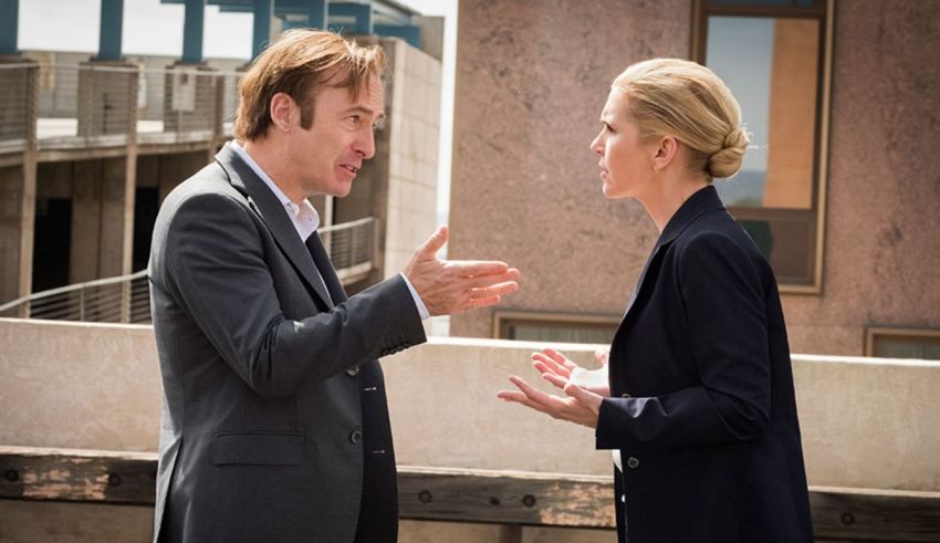 A man and a woman talking on a rooftop.