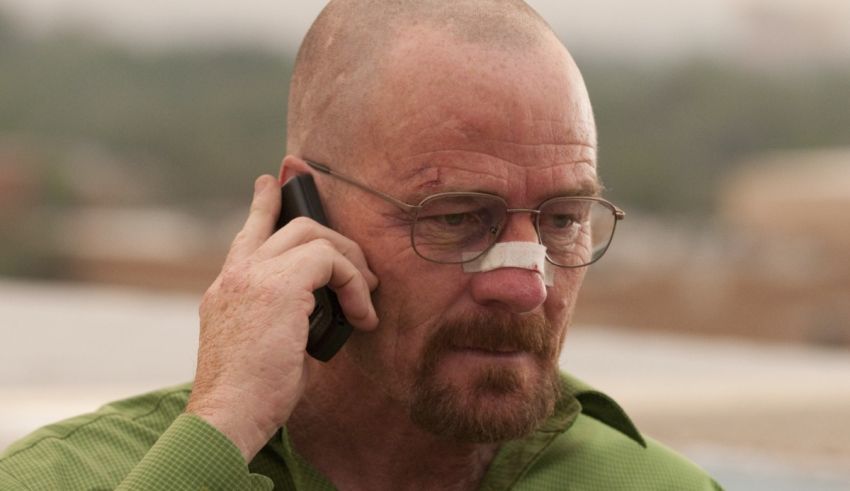 A man talking on a cell phone in a green shirt.