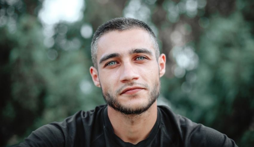 A man in a black shirt is looking at the camera.