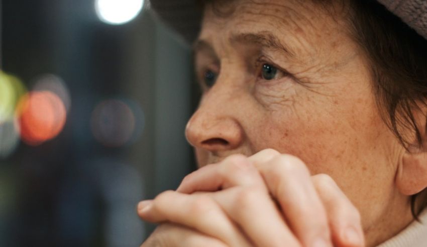A woman in a hat is looking at the camera.
