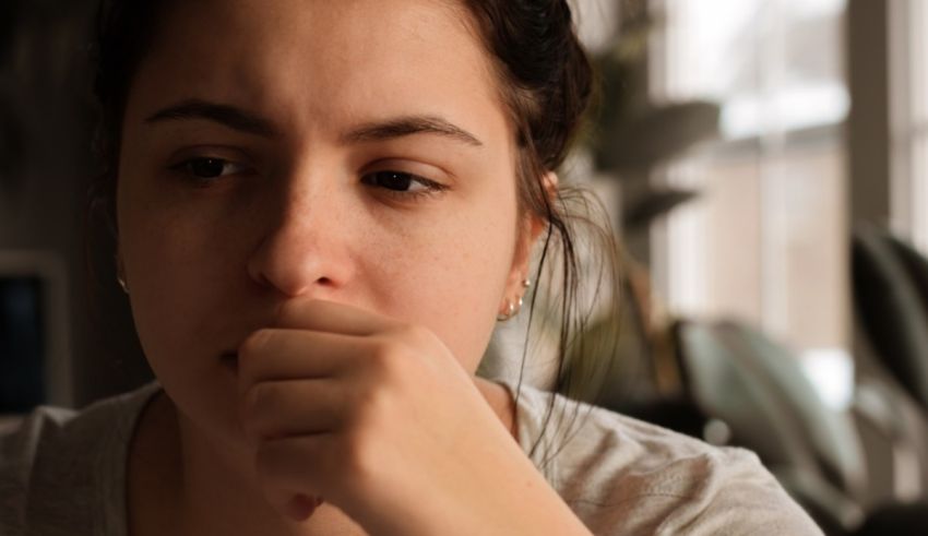 A young woman with her hand on her chin.
