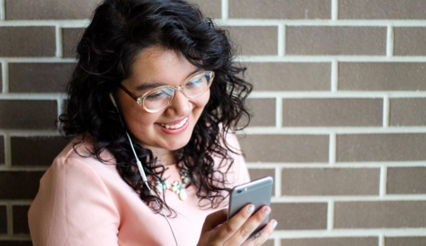 A woman listening to music on her cell phone.