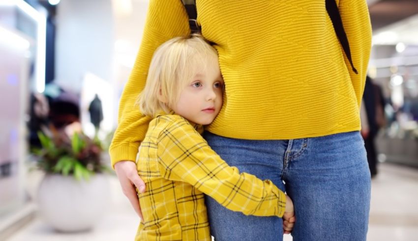 A woman is hugging her child in a shopping mall.