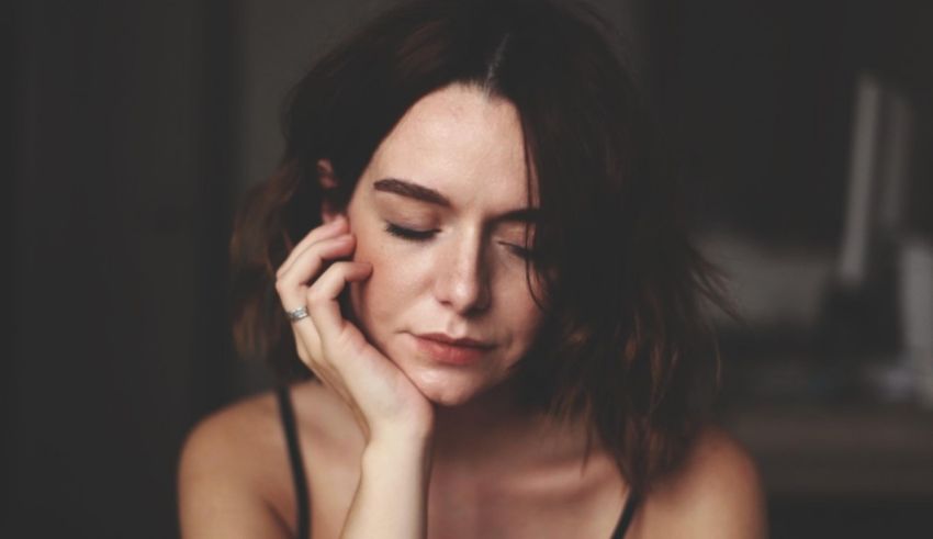 A woman with her hand on her face.