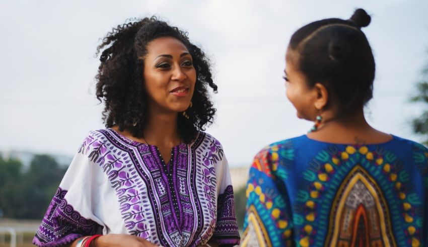 Two african women talking to each other.