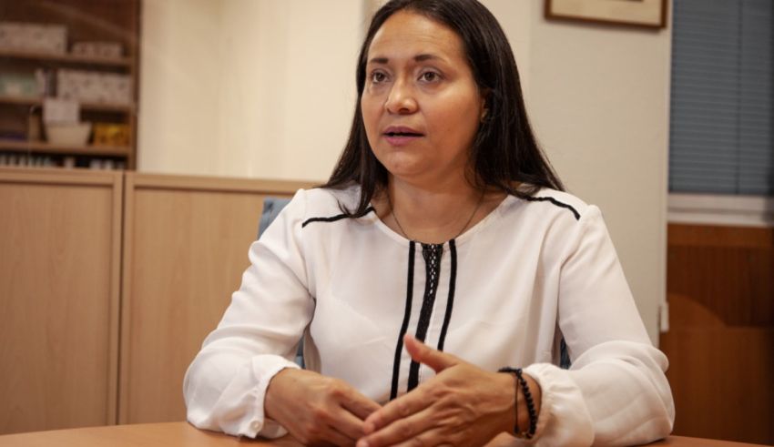 A woman sitting at a table in an office.