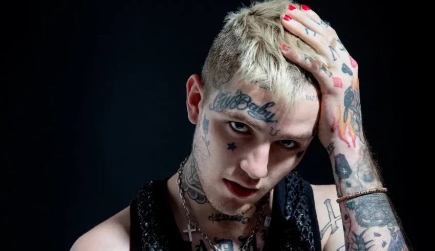 A young man with tattoos on his head.