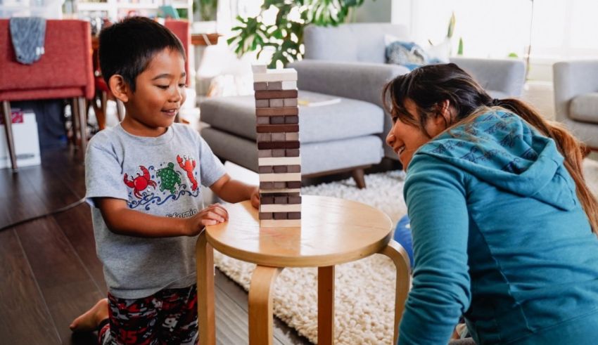 A mother and child playing with wooden blocks in a living room.