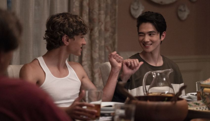 Two young men sitting at a dinner table.