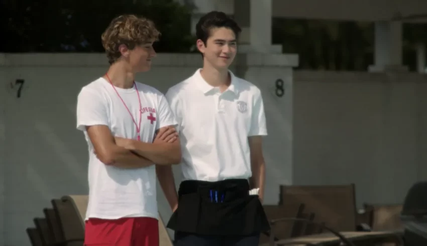 Two young men standing next to each other.