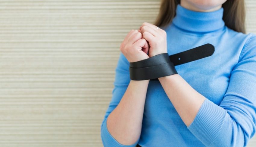 Woman with handcuffs on her wrists.