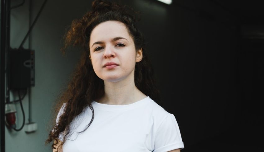 A young woman wearing a white t - shirt.
