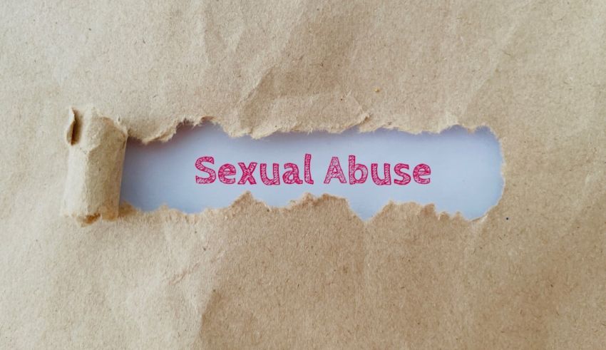 The word sexual abuse is torn out of a piece of paper.