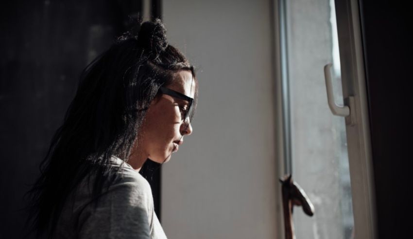 A young woman looking out of a window.