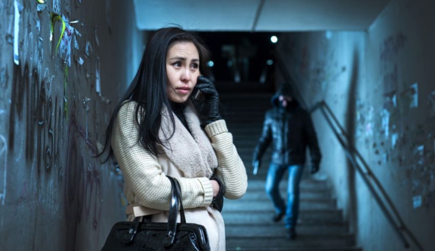 A woman talking on a cell phone in an alleyway.
