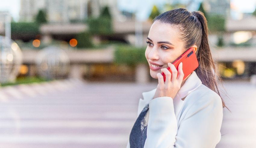 A woman is talking on a cell phone in a city.
