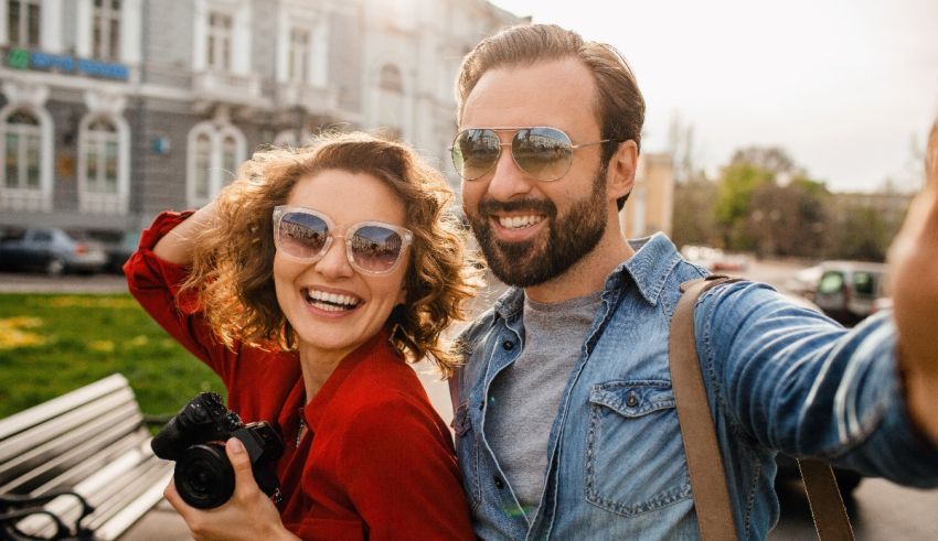 A man and woman are taking a selfie in front of a building.