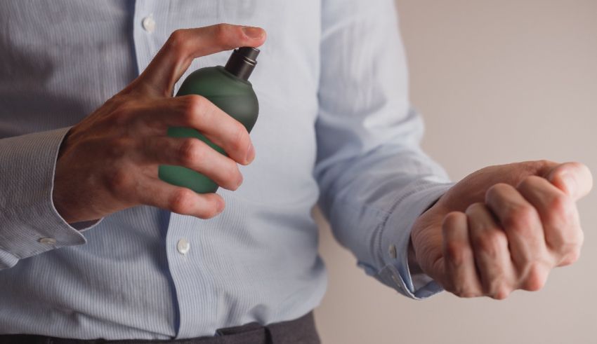 A man is holding a bottle of hand sanitizer.
