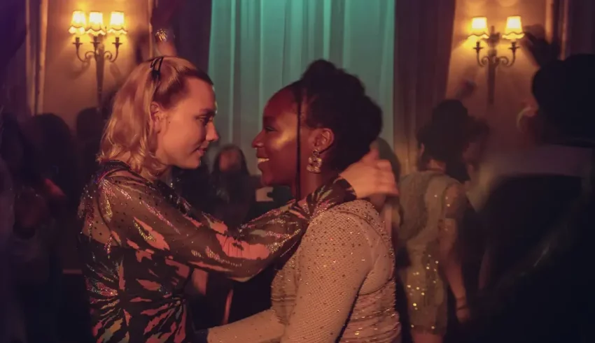 Two women hugging each other at a party.