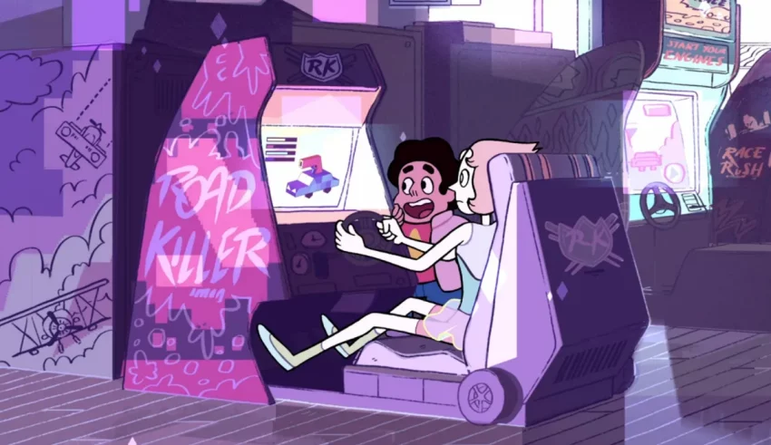 A girl is sitting in a video game machine.