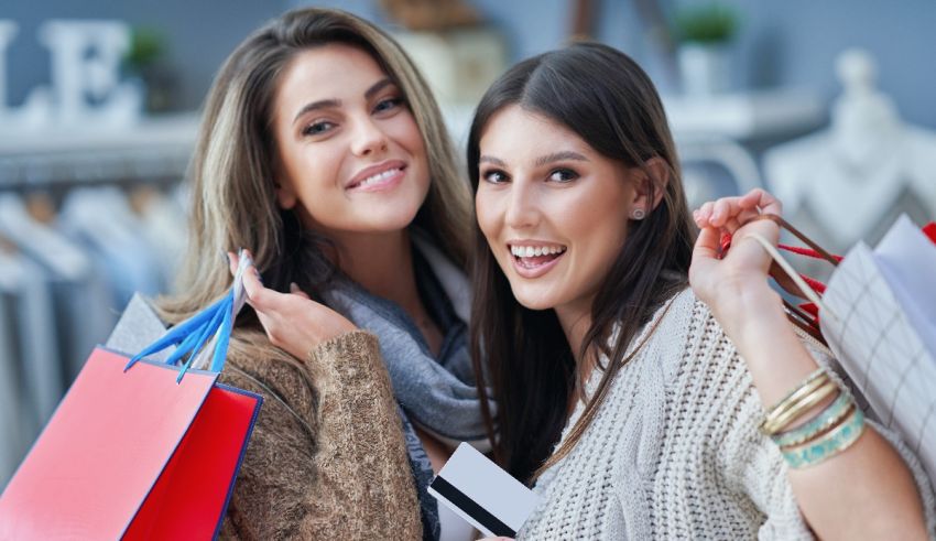 Two women holding shopping bags in a store.