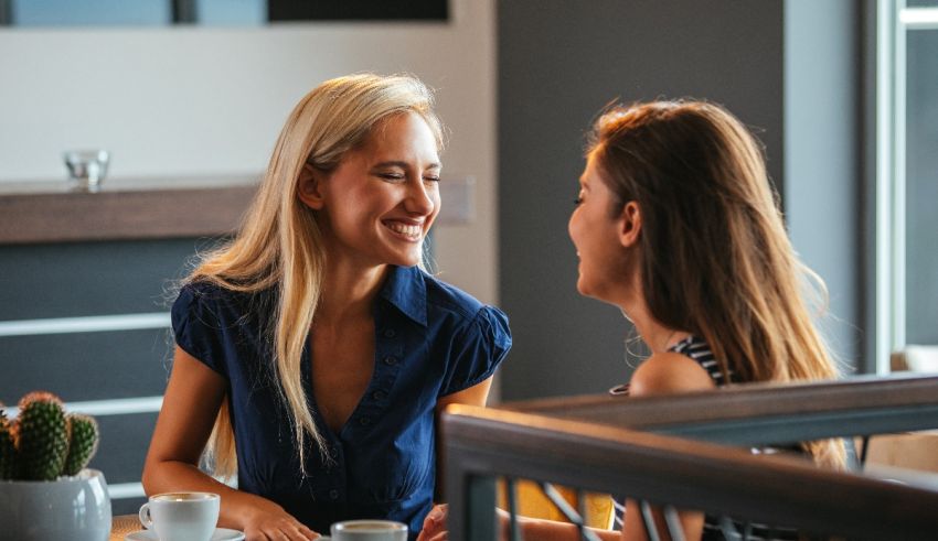 Two women talking at a table in a cafe.