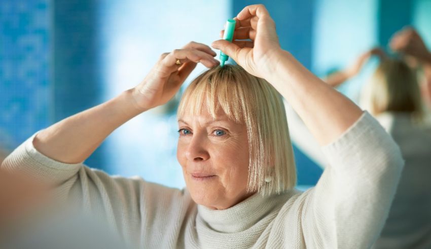 A woman is brushing her hair in front of a mirror.