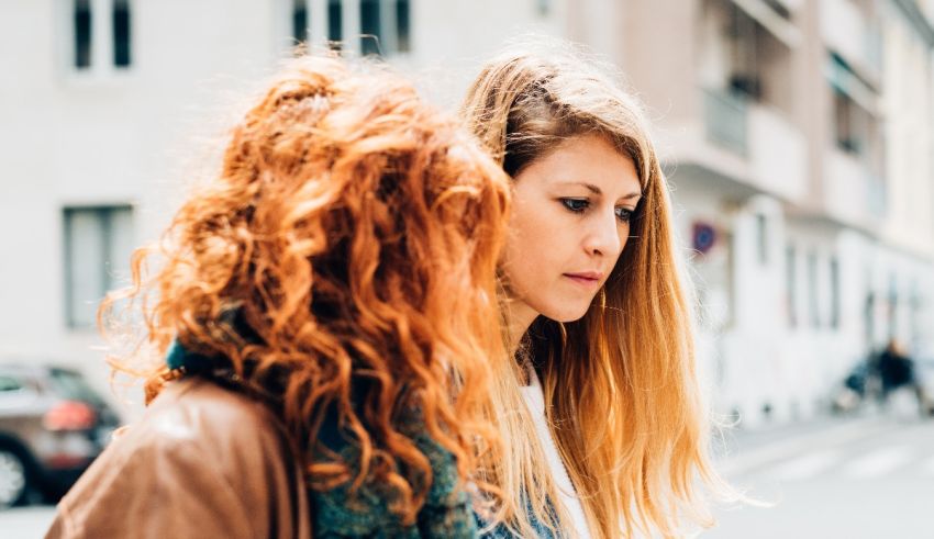 Two women looking at each other on the street.