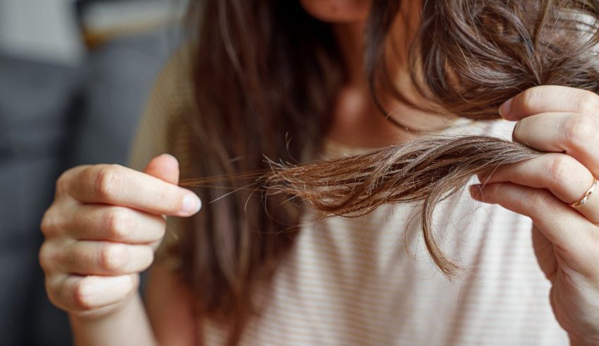 A woman is combing her hair with her fingers.