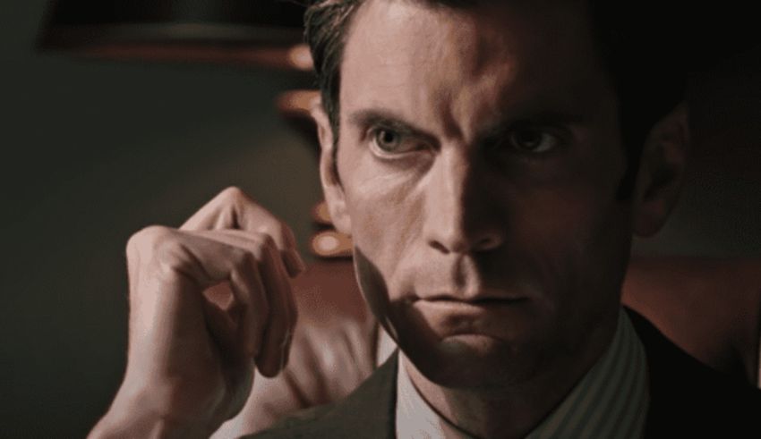 A man in a suit is staring at something.