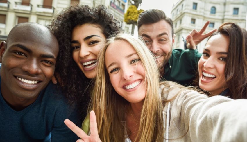 A group of friends taking a selfie in a city.