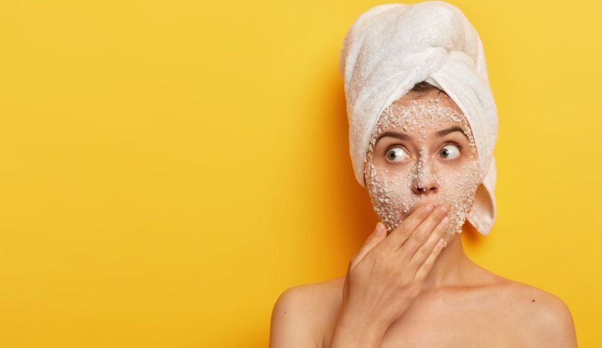 A woman with a towel covering her face with a face mask.