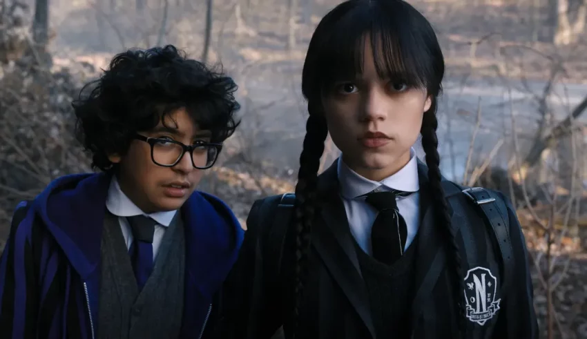 Two girls in school uniforms standing next to each other.